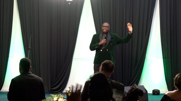 A speaker addressing the room