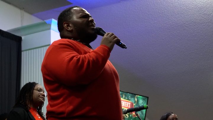 A soloist in a red sweater