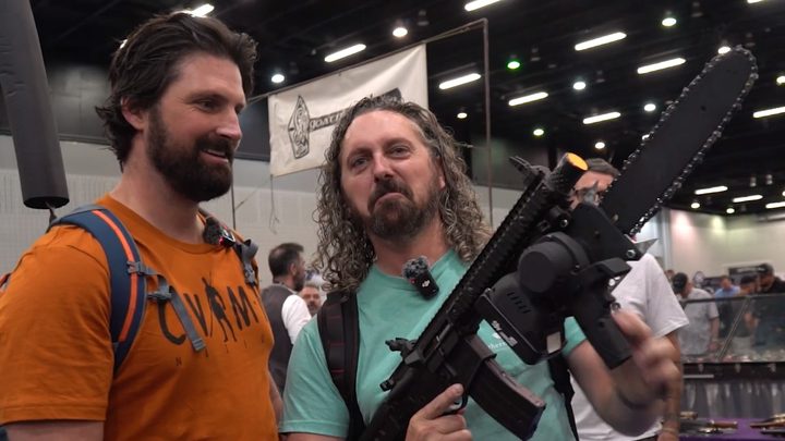 Checking out a chainsaw on the show floor