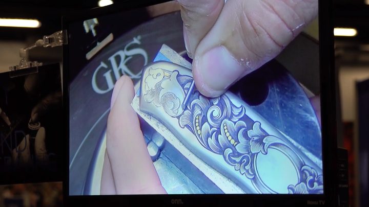 Close-up of hand engraving on a monitor
