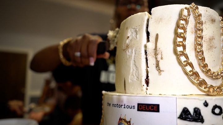 Cutting the gold-chain birthday cake