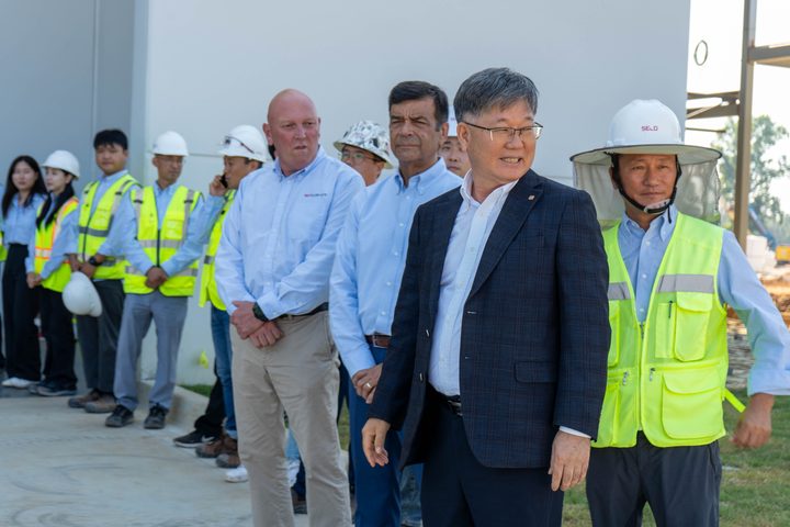 Greeting the hard-hat crew outside the facility