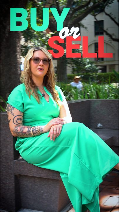 A 'Buy or sell' title, seated in a downtown square